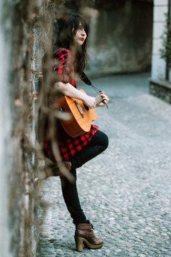 Woman playing an acoustic guitar