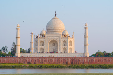 The Taj Mahal Mausoleum in Agra, India, seen from the other bank of the Yamuna river, near the Garden of the Moon, at sunset.