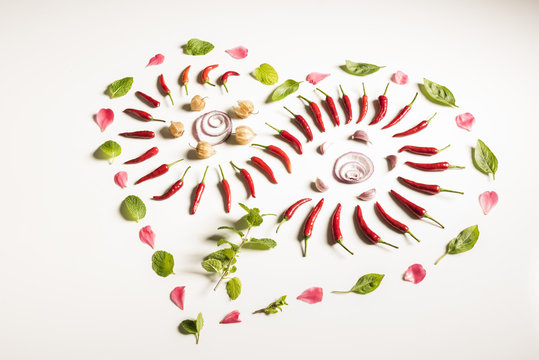 Abstract food art-chili, mint, basil, onion, garlic arranging on white background.