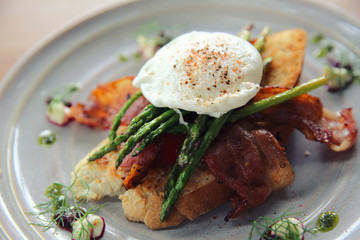 eggs benedict poached egg on bacon asparagus and bread breakfast