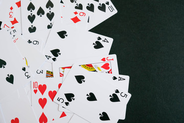 Lot of dusty old playing cards. set black cards on the black ground, playing card. playing cards scattered on a table, the concept of passion, risk