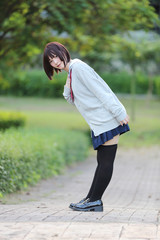 Portrait of Japanese school girl with countryside park