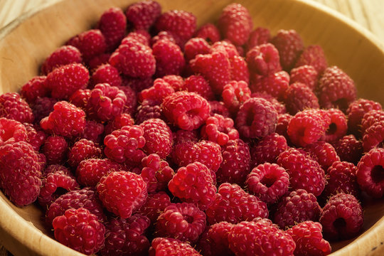 raspberries in a plate,in wooden bowl,basket/bush branch/growing raspberries,raspberries background closeup photo,high resolution product,Delicious first class organic fruit,Raspberry as background