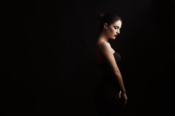 portrait of a girl in profile on a black background with red lips