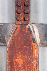 Steel construction beams indoors in the shape of a human with blocks head.