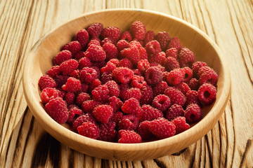 raspberries in a plate,in wooden bowl,basket/bush branch/growing raspberries,raspberries background closeup photo,high resolution product,Delicious first class organic fruit,Raspberry as background