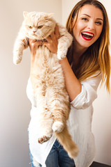 Beautiful girl with a red cat