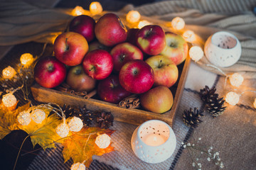 basket of apples and surrounded by candles and garlands