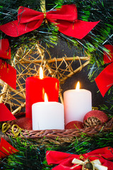 Christmas decoration burning candles spruce branches, Christmas balls on a dark background with copy space, festive mood and atmosphere