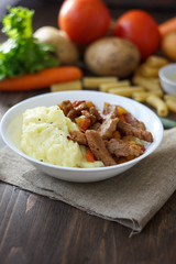 Soy meat with potato puree over kitchen table.