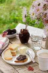 Toasts with plum chocolate jam and cocoa. Breakfast in the garden. Rustic style, selective focus.