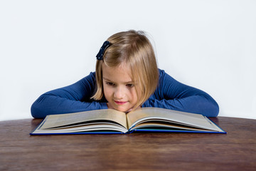 little girl with a book on a white background