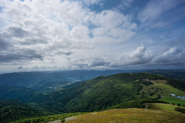 Fototapeta premium France - Scenic view down from a mountain on endless green forest and mountains