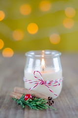 Obraz na płótnie Canvas Candle in glass jar with Christmas decorations.