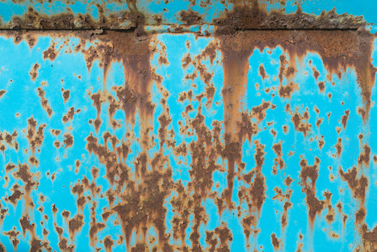 colorful aqua blue metal surface covered in rust
