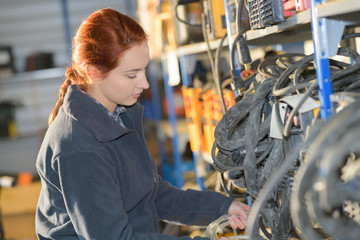 Fototapeta premium young female mechanic working at a garage