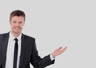 Happy smiling business man showing blank area for sign or copysp