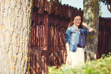 A middle-aged woman rests on a city waterfront on a day off. The concept of femininity and romance...