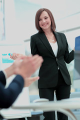 Successful  Woman making a business presentation to  group