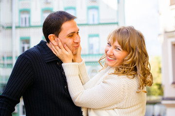 A cheerful and positive couple man and woman are walking in the city, relaxing and enjoying time with each other. The concept of feelings and love in middle-aged people
