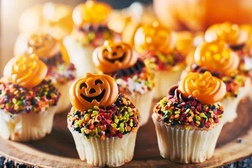 Gordijnen festive halloween pumpkin cupcakes with chocolate frosting and colorful sprinkles © Joshua Resnick