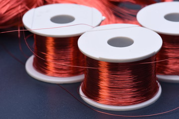 Copper electric coil and wire on metal background
