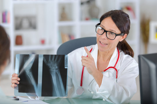 lady doctor in uniformslooking at x-ray