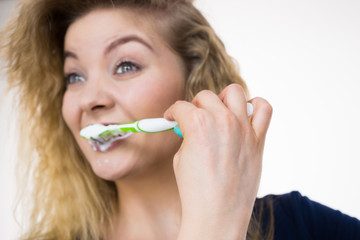 Woman brushing cleaning teeth