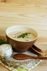 Soup with forest mushrooms on cream, with rye bread and parsley. Selective focus. Vertical.