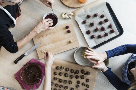 Family making homemade chocolate and marzipan candy