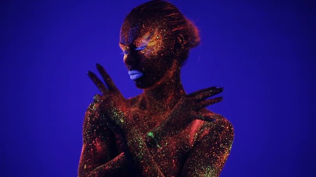 girl's hands glow in ultraviolet light