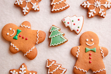 beautiful Christmas background with gingerbread men, Christmas trees and snowflakes with pine cones