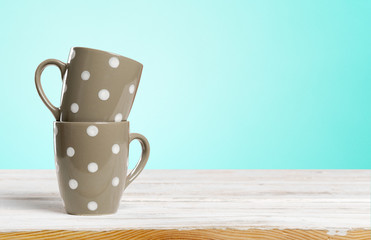 coffee mugs on wood background
