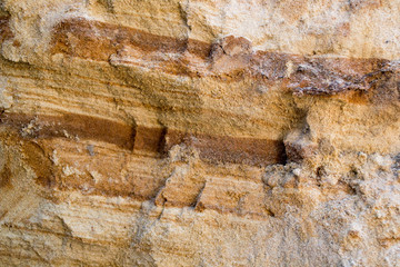 Bright yellow orange background with layers of sand and clay