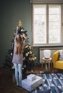 Caucasian Girl Decorating the Christmas Tree