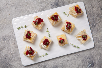 Holiday appetizers with cranberry, brie and thyme