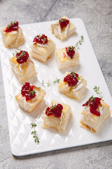 Holiday appetizers with cranberry, brie and thyme