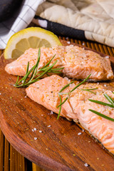 Salmon fillets. Grilled salmon, rosemary - herb decorationon on vintage pan or wooden board. roasted fish , wooden table. Studio shot.