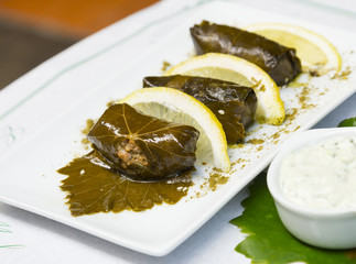 Plate of dolma with lemon - traditional mediterranean cuisine