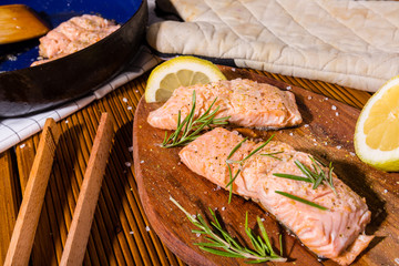Salmon fillets. Grilled salmon, rosemary - herb decorationon on vintage pan or wooden board. roasted fish , wooden table. Studio shot.