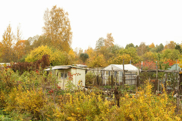 Fototapeta na wymiar Small garden houses in autumn.