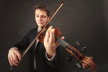 Man playing violin showing emotions and expressions