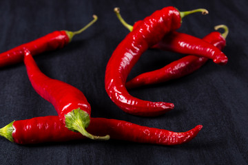 Chili.Red chili peppers on black slate board. Selective focus.
