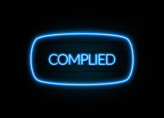 Complied  - colorful Neon Sign on brickwall
