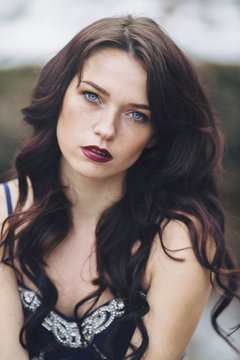 Portrait of a beautiful woman with blue eyes and freckles