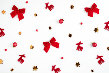Christmas background. Decorations for Christmas, red figures of deer and bows, beads, shiny stars and white background. Ready Christmas background for your text and design