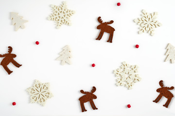 Christmas background. Postcard from Christmas figures of Christmas tree, deer and snowflakes, red beads on a white background. Ready Christmas background for your design
