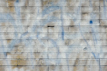 White spray paint covering graffiti markings on building wall