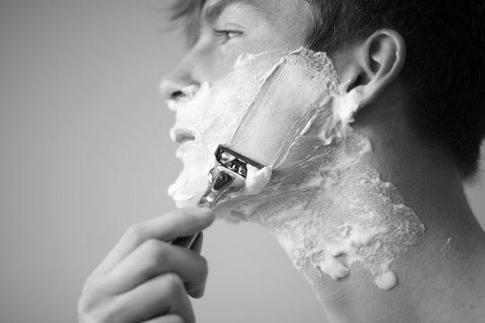Young man shaving
