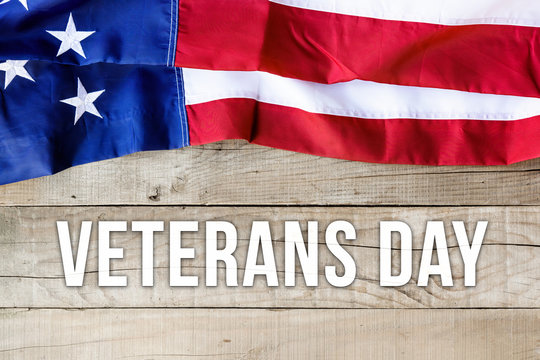 American flag over wooden background - Veterans Day